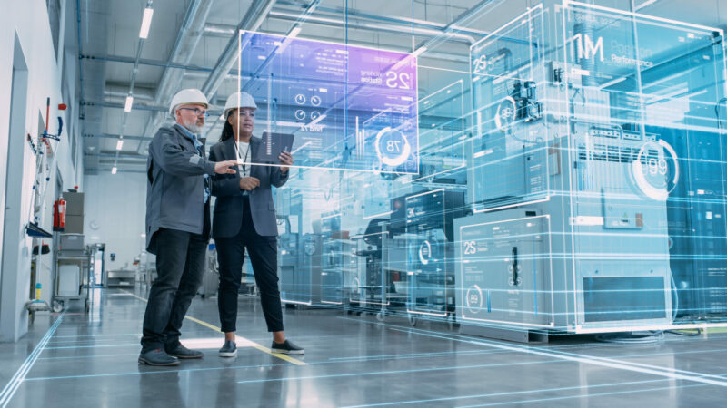 Factory Digitalization: Two Industrial Engineers Use Tablet Comp